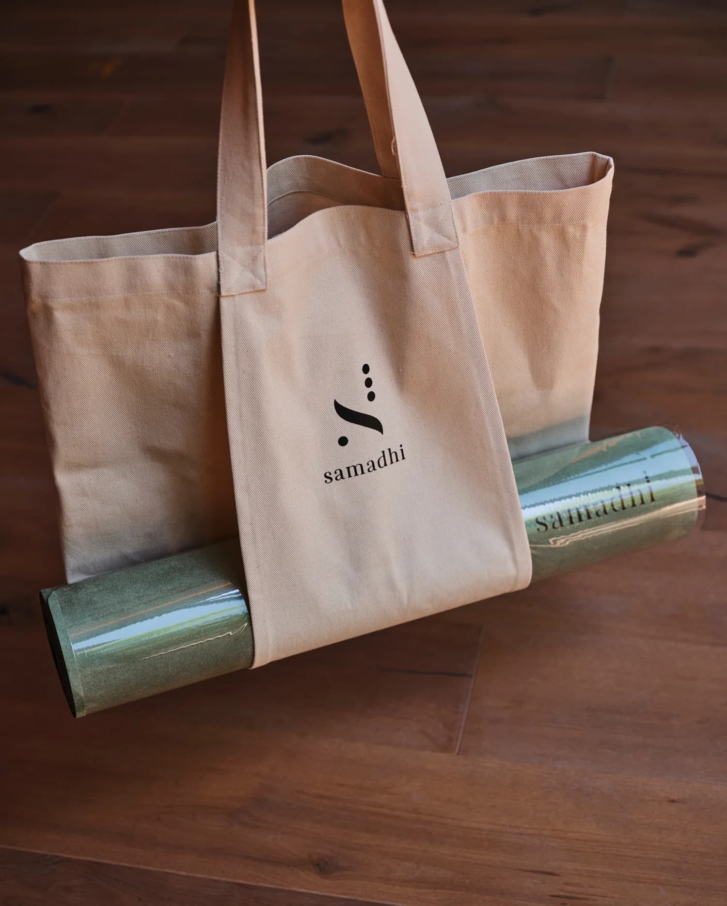 Samadhi branded canvas tote bags with logo on wooden background