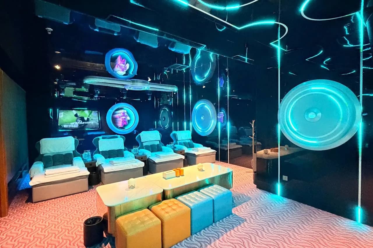 Contemporary spa relaxation lounge with neon-lit decor, seating areas, and modern furnishings