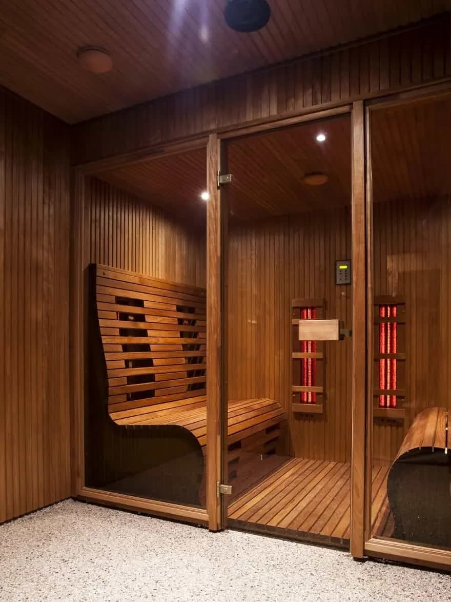 Spa sauna rooms with wooden interiors and red light therapy panels