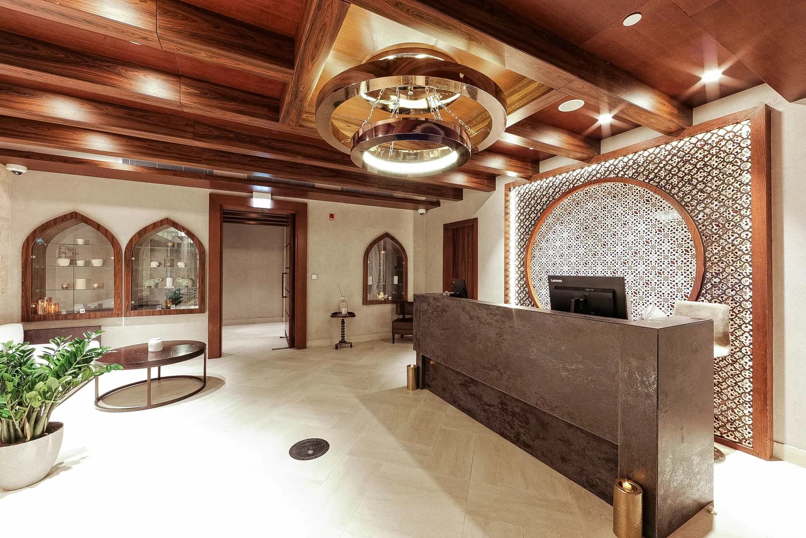 Luxurious spa reception desk with modern wood ceiling and geometric wall screens