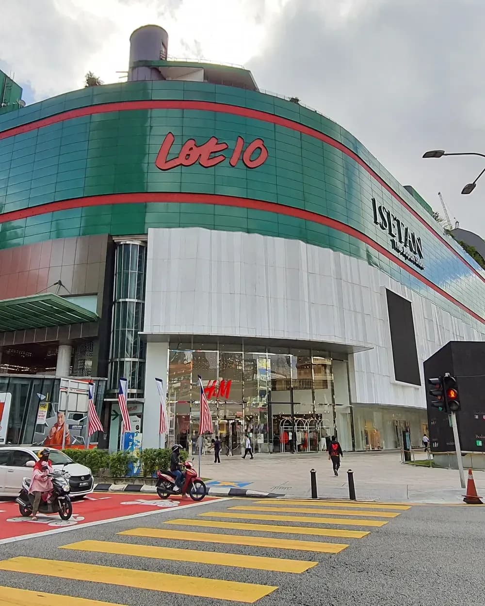 Metapark @ Lot 10 mall exterior with curved green and red facade and main entrance plaza