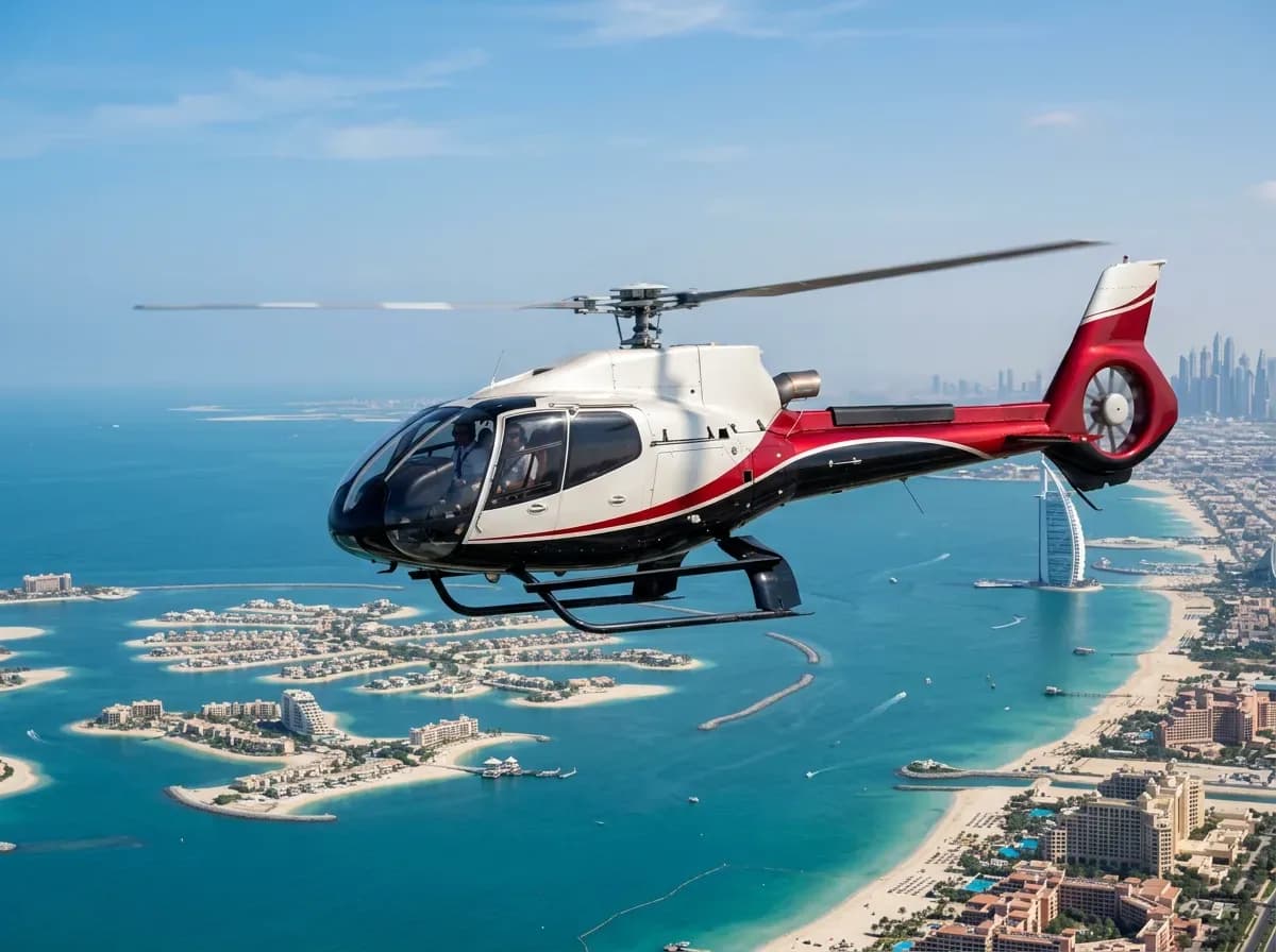 Red and white helicopter flying over Palm Jumeirah and Dubai's turquoise coastline