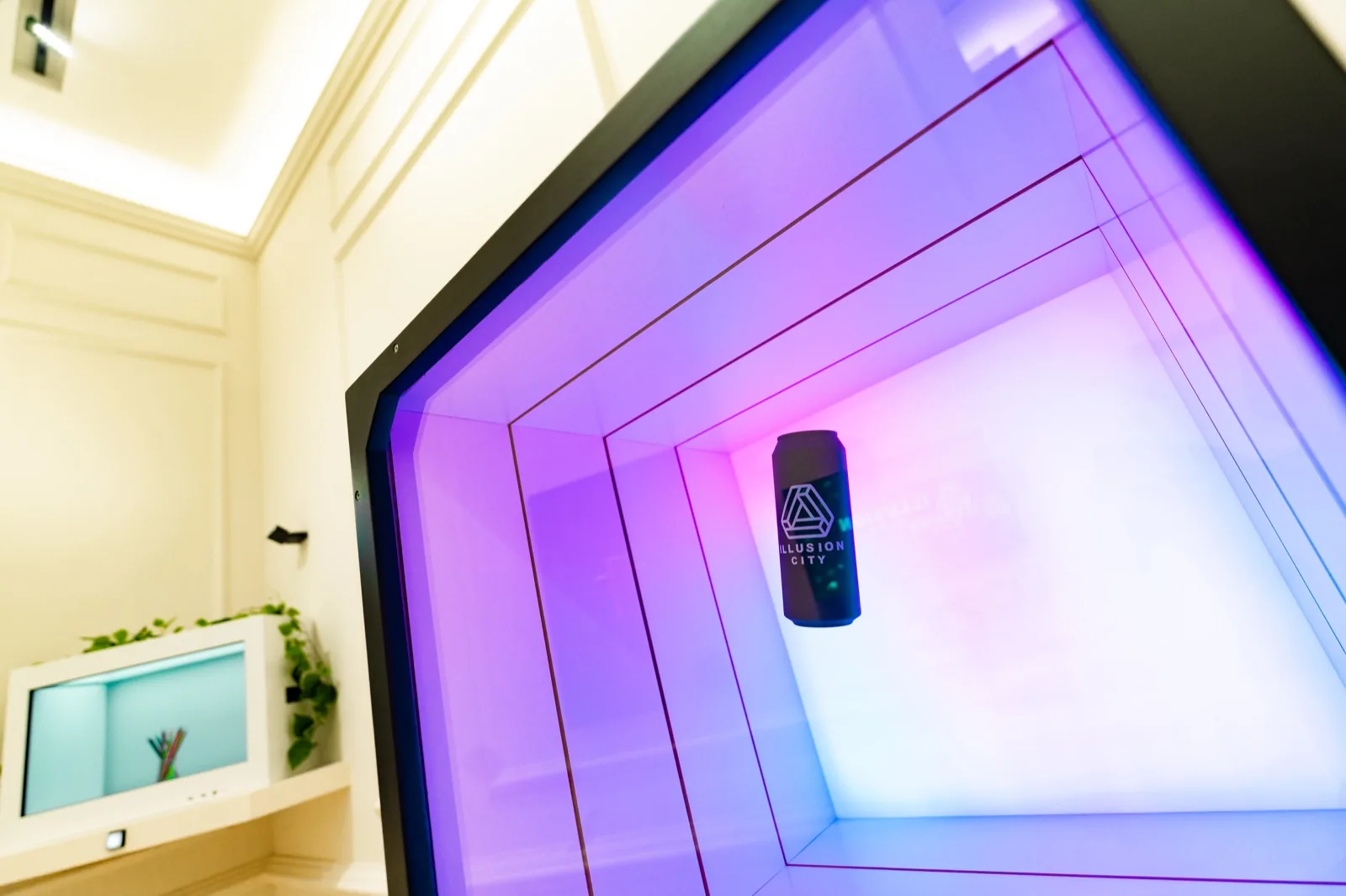 Purple neon-lit geometric chamber with a suspended display object in a modern museum setting.