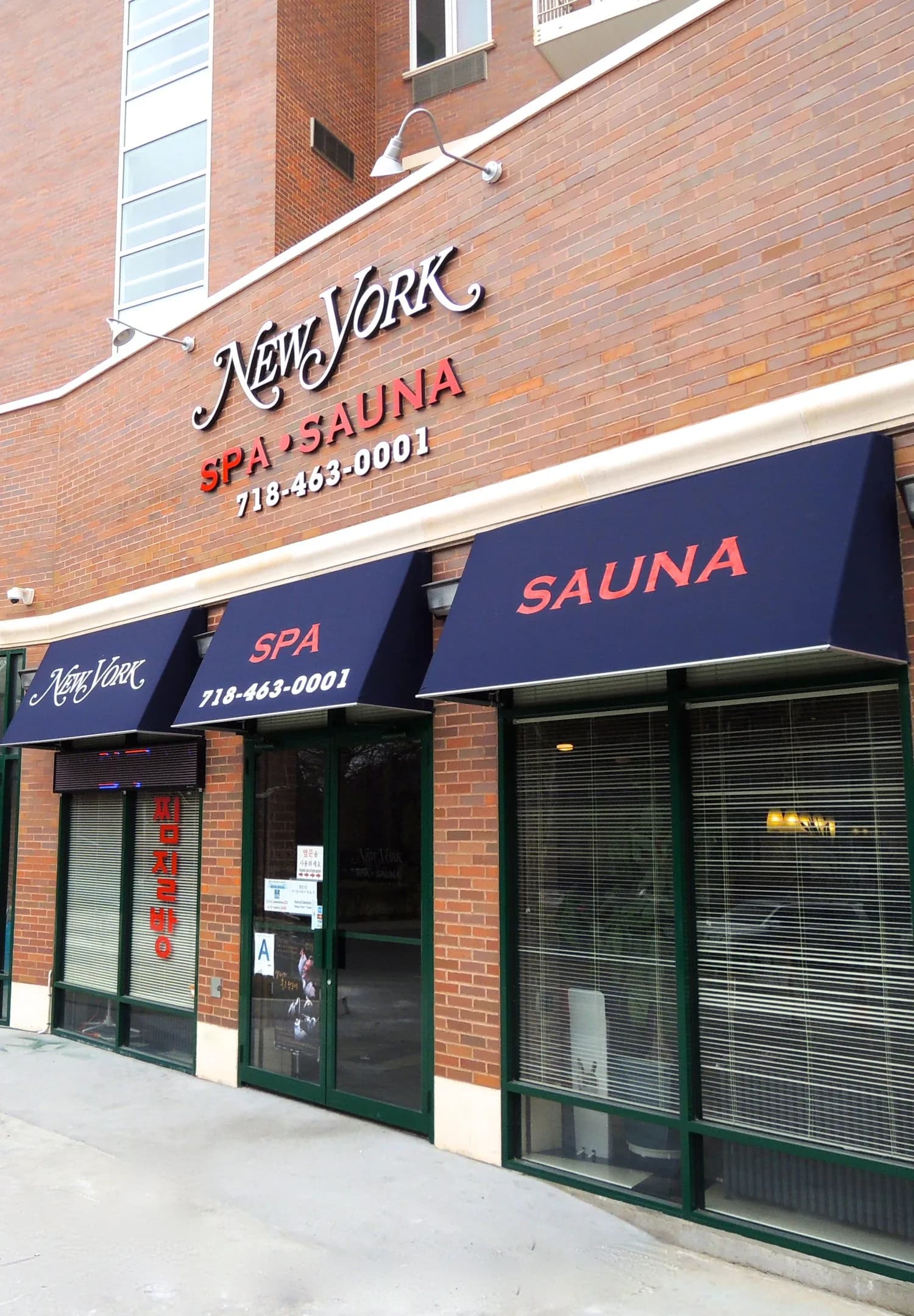 New York Spa & Sauna storefront with navy awnings on a brick building