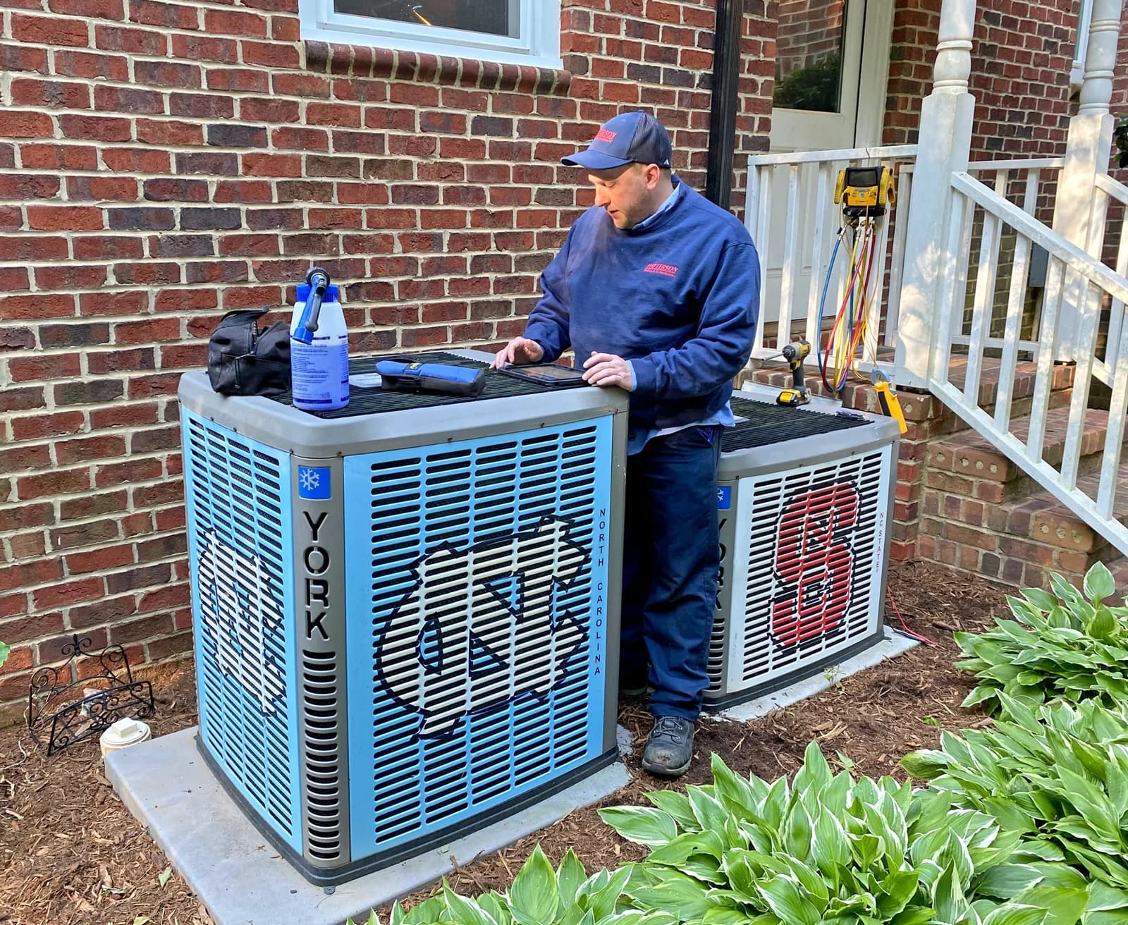 HVAC technician servicing York air conditioning units at residential home