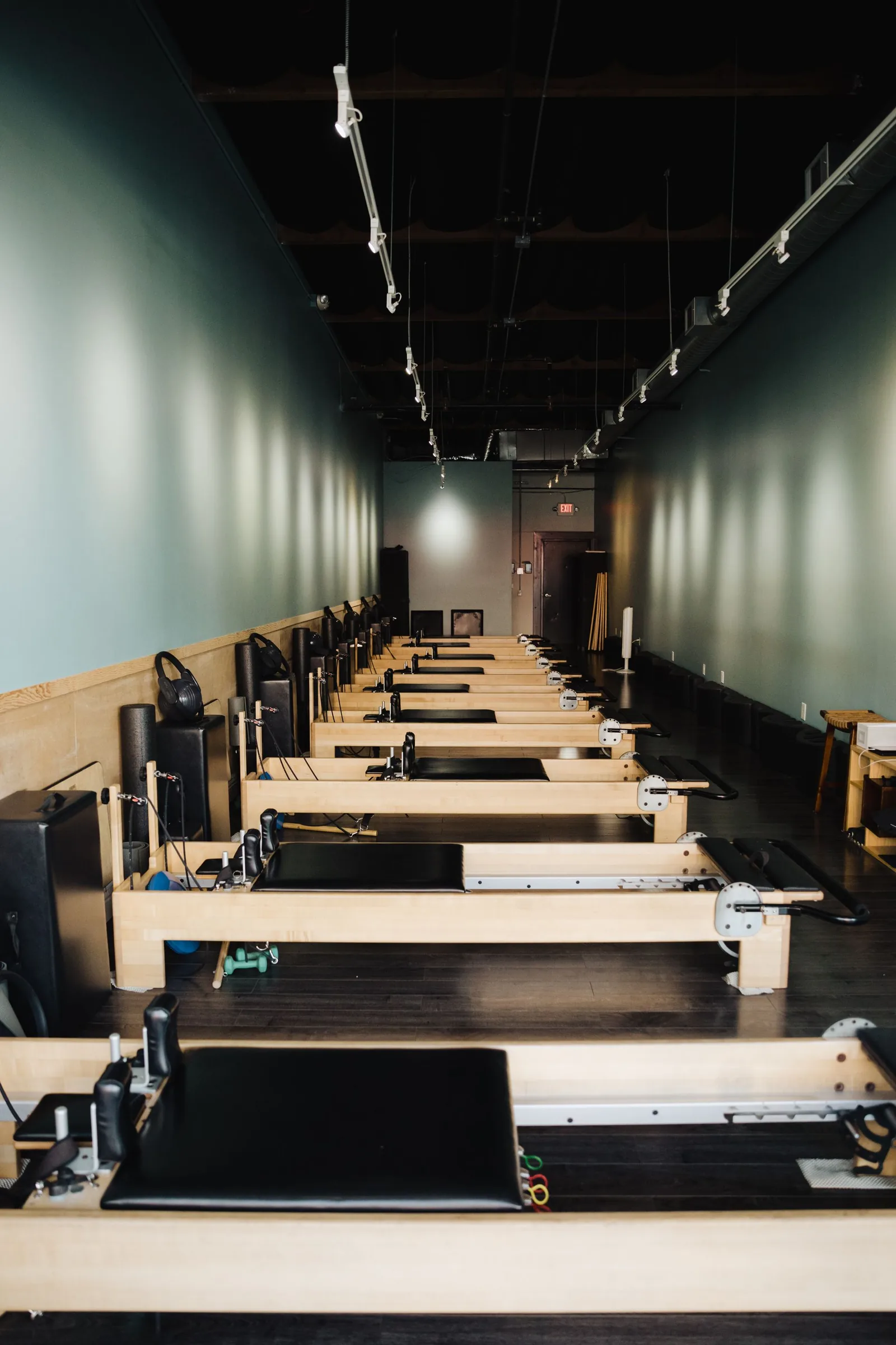 Pilates reformer studio with multiple machines in a light-filled room