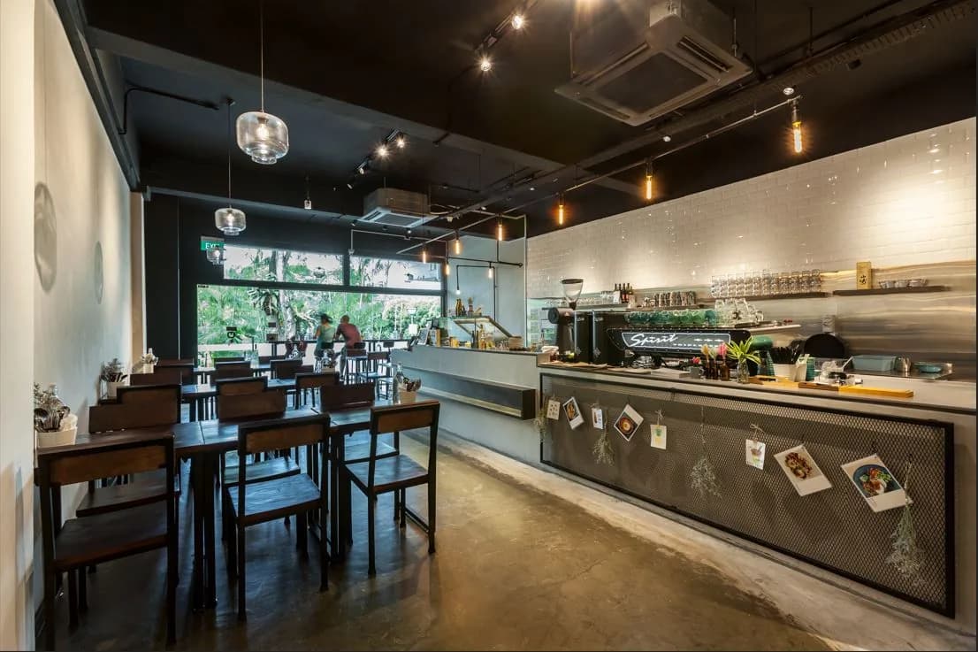 Contemporary café interior with counter, seating, and natural light from front windows