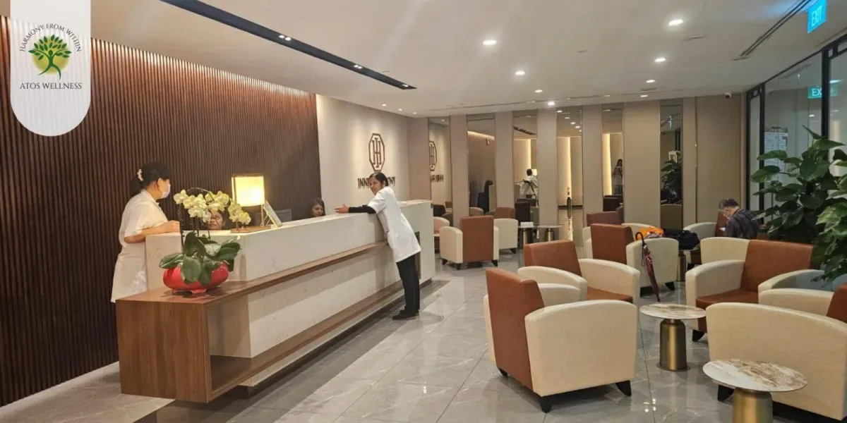 Atos Wellness spa reception area with desk, comfortable seating, and modern interior design