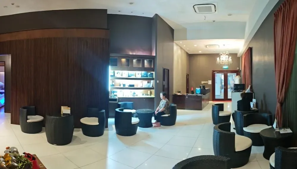 Spa reception area with black modern furnishings, product displays, and reception desk
