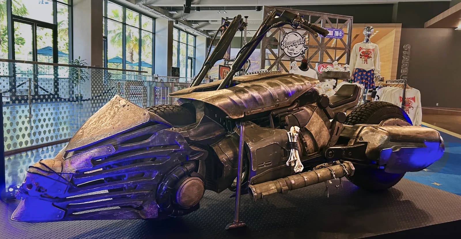 Illuminated mechanical dragon prop in a studio tour exhibition hall with merchandise displays