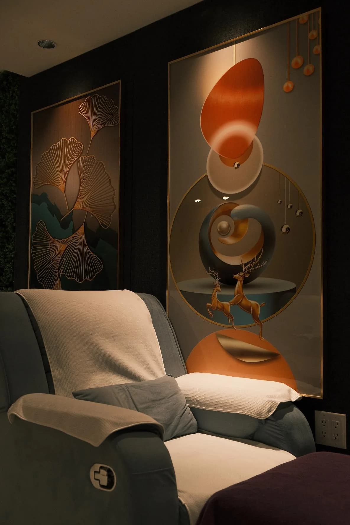 Modern spa room with artistic wall panels, reclining chair, and ambient lighting in warm tones