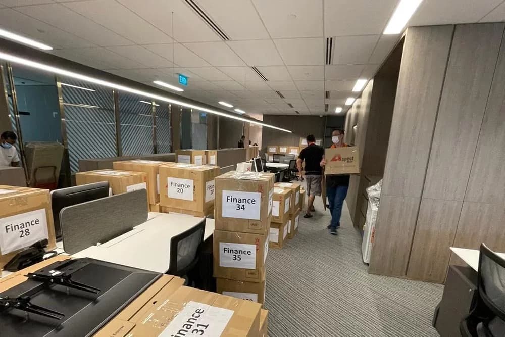 Moving operation in progress with labeled cardboard boxes in a modern warehouse space
