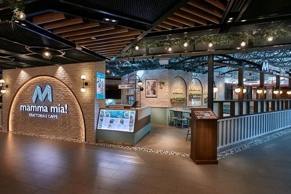 Modern Italian restaurant interior with neon Mamma Mia sign, counter service area, and contemporary lighting
