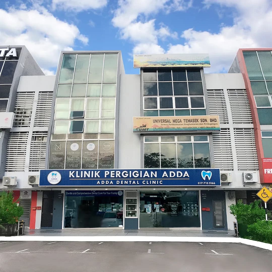 Klinik Pergigian Adda dental clinic storefront with blue signage on a modern multi-story building