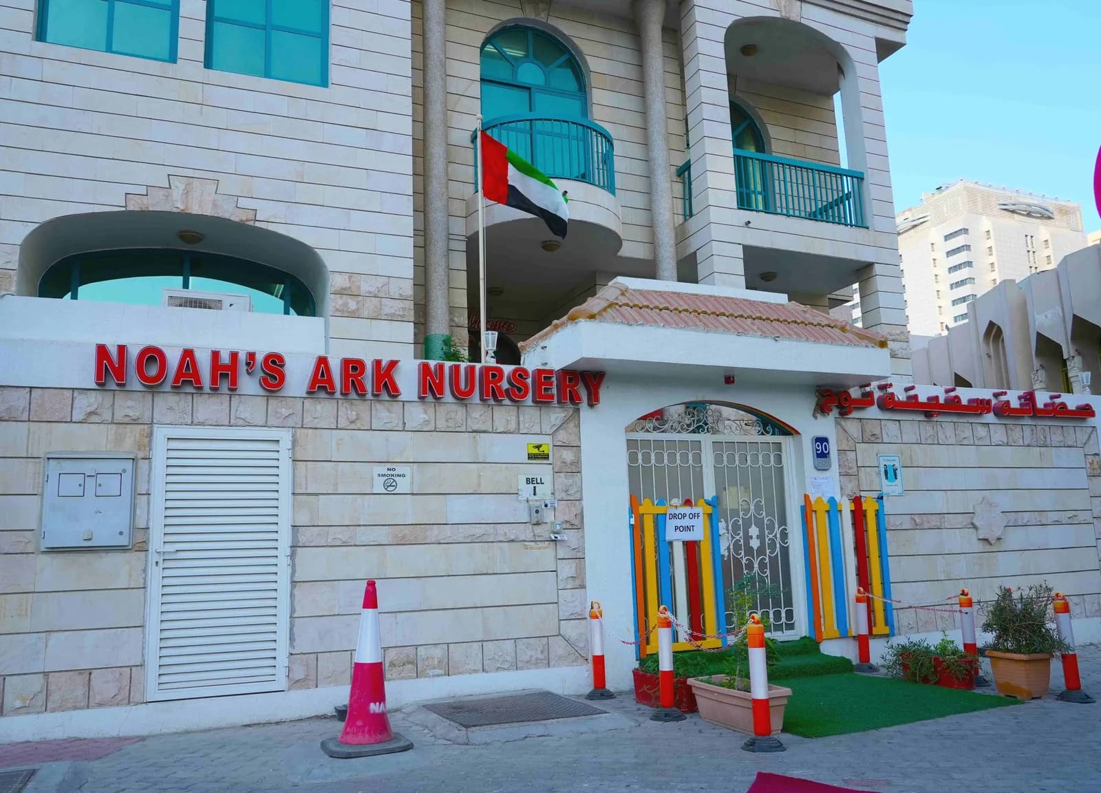 Noah's Ark Nursery storefront with red signage, colorful entrance, and UAE flag on building facade