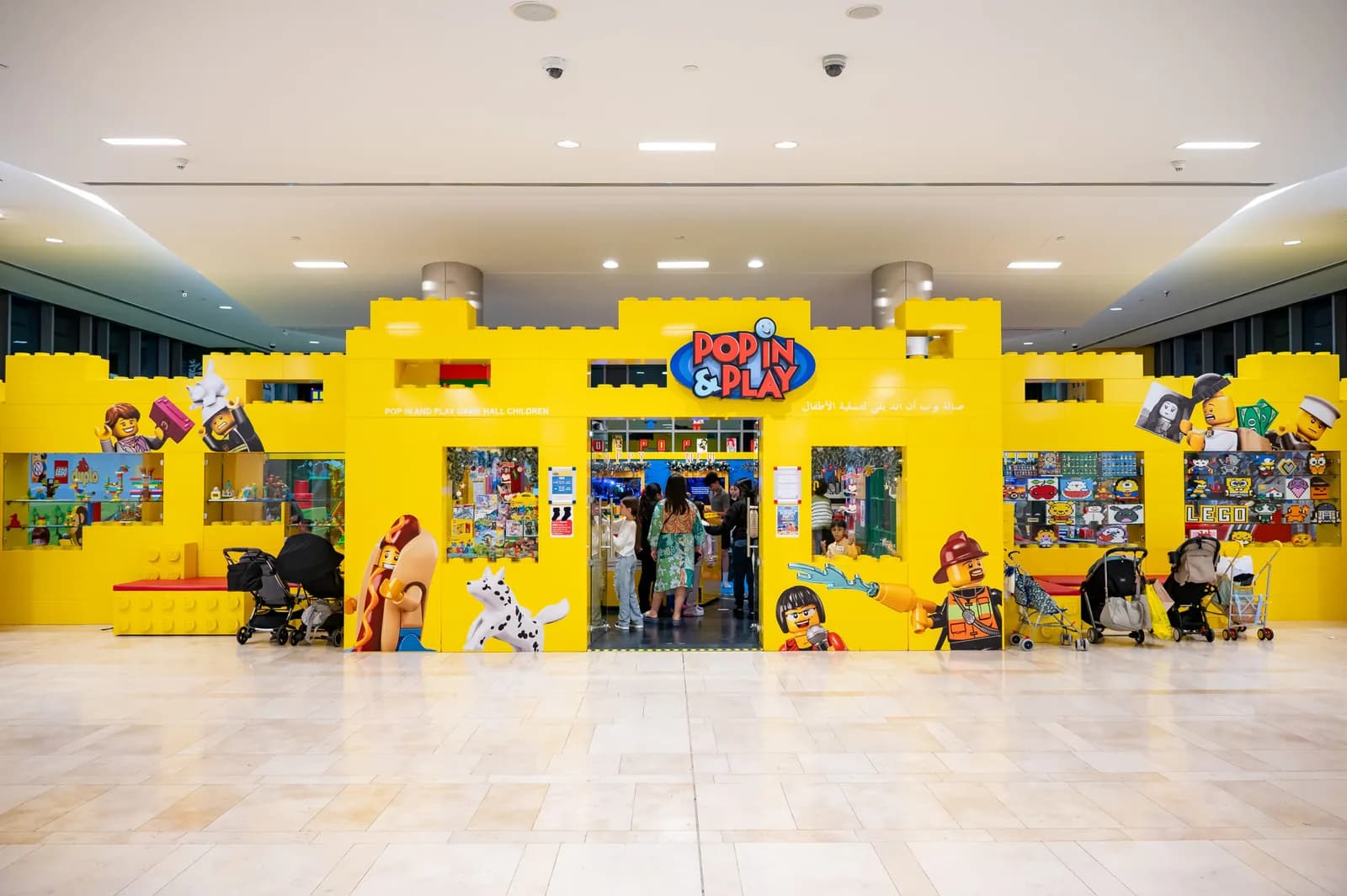 Bright yellow Pop In and Play storefront in Capital Mall with character graphics and entrance