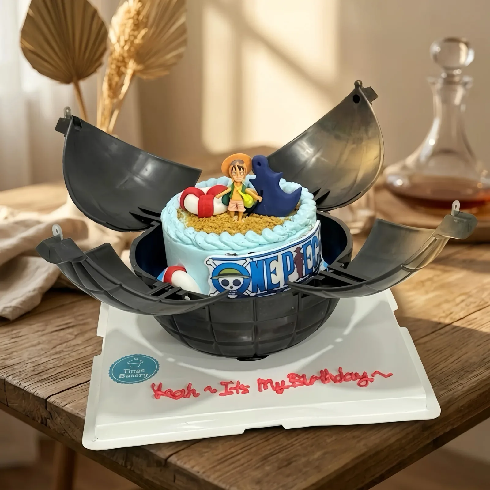 Custom pirate ship cake with anime character toppers and blue frosting