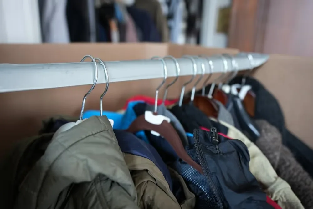 Jackets and outerwear on metal hangers on a clothing rack