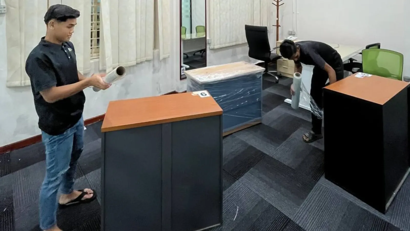 Moving team packing office furniture and boxes for relocation service