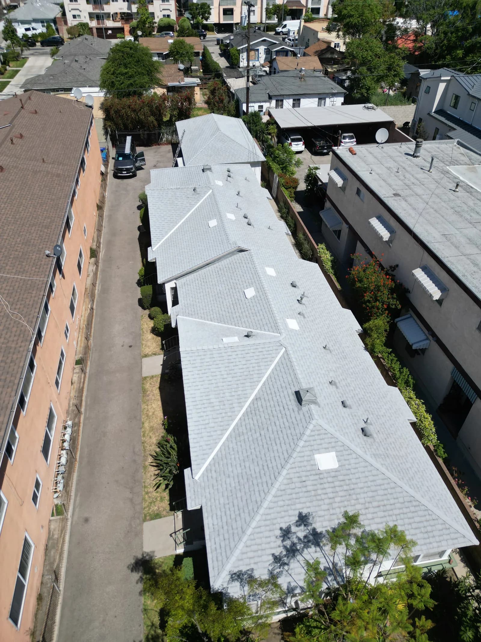 Aerial view of newly installed white metal roof on residential home