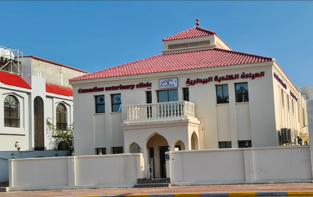 Canadian Veterinary Clinic exterior with white walls, red tile roof, and arched entrance