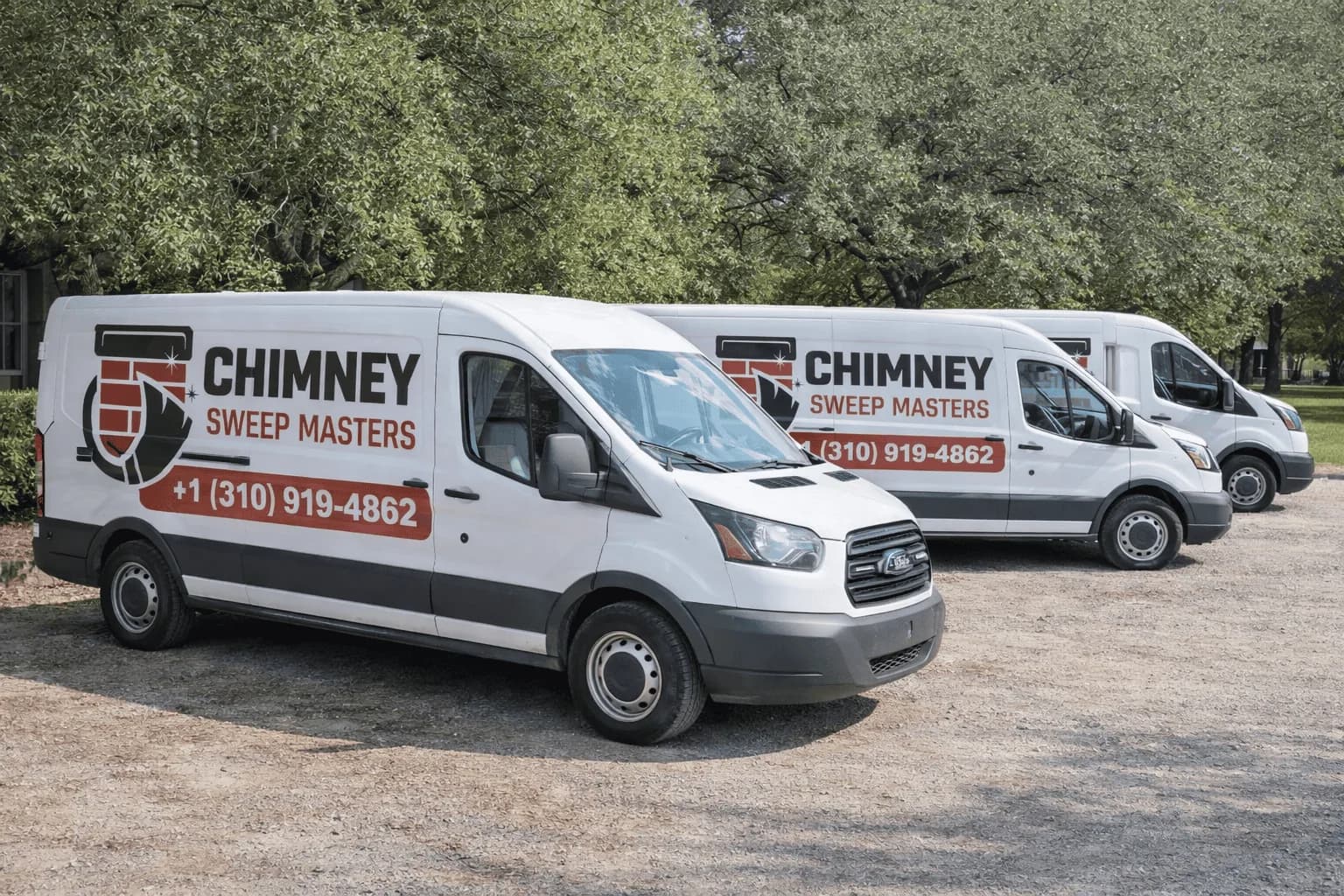 Three white service vans branded with Chimney Sweep Masters logo and phone number parked outdoors