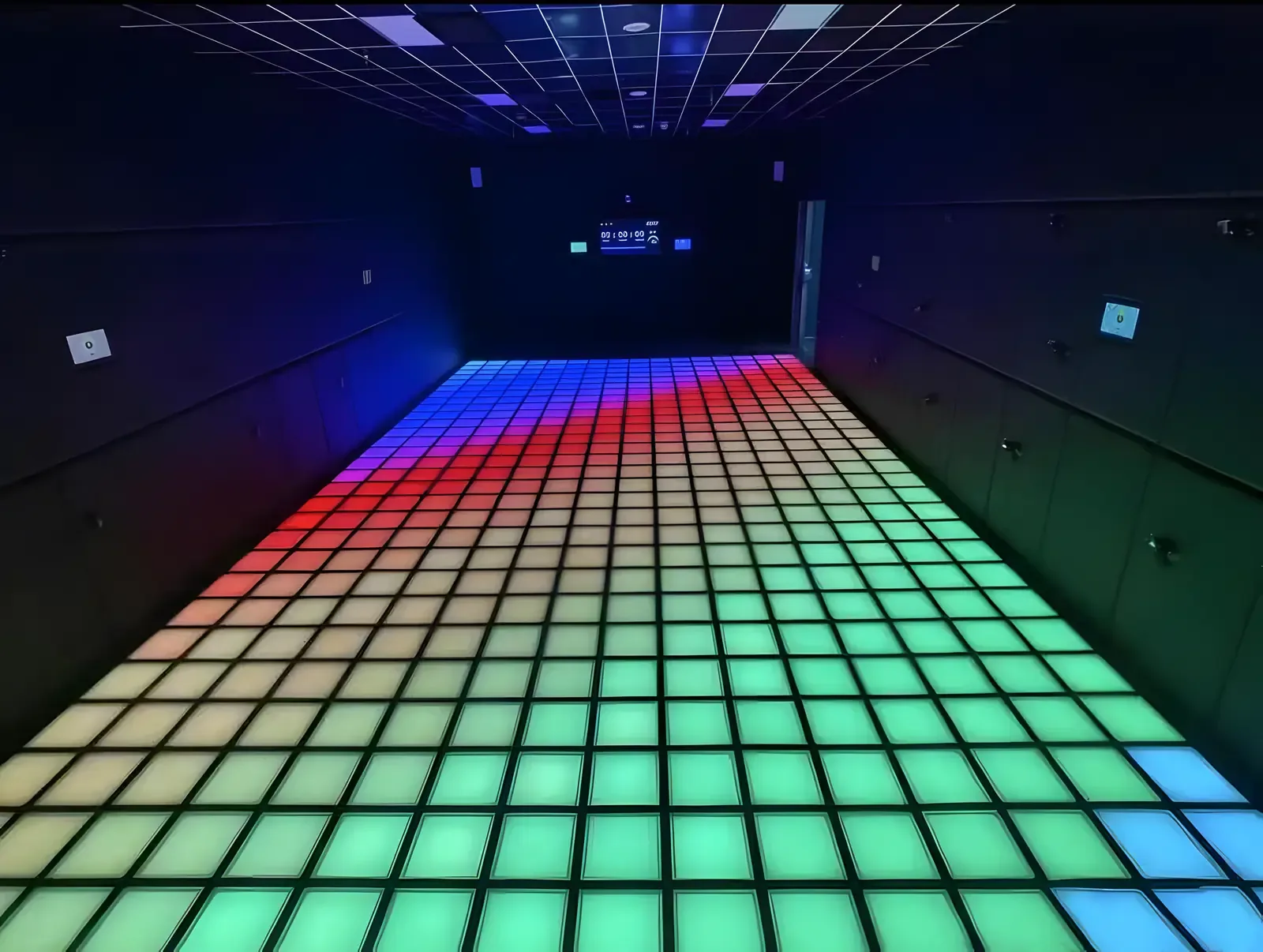 Illuminated dance floor with colorful grid lighting in blue, green, red and purple tones