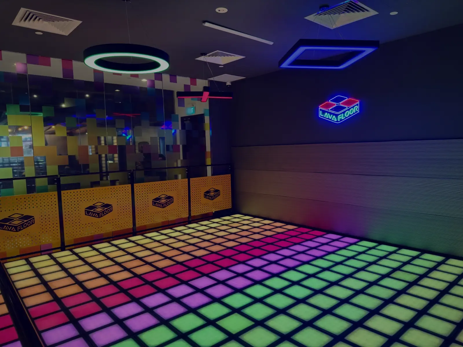 Lava Floor venue with vibrant LED dance floor, neon sign, and modern interior design