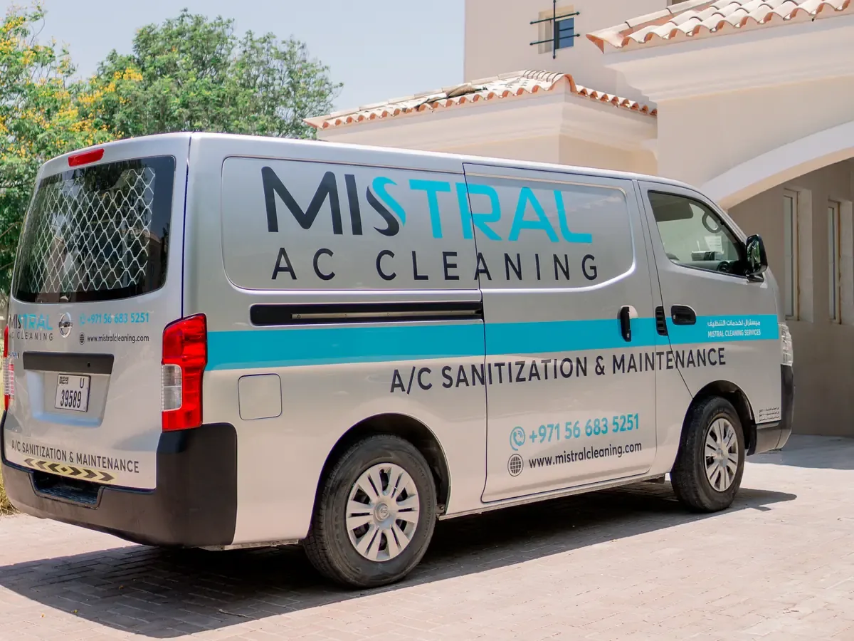Mistral AC Cleaning service van with company branding parked in front of a building